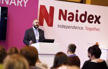 Naidex logo and speaker