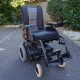 An Invacare Fox powerchair on tarmac.