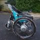 A side view of the Trekinetic GTE powerchair, in teal.